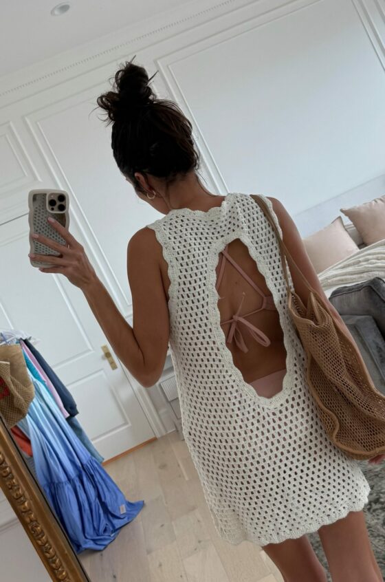 Christine Andrew in a white crochet swimsuit coverup from Amazon