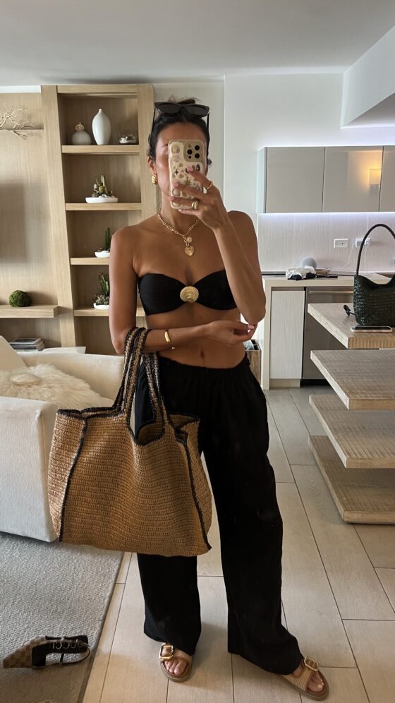 Christine Andrew in a black affordable beach vacation outfit 