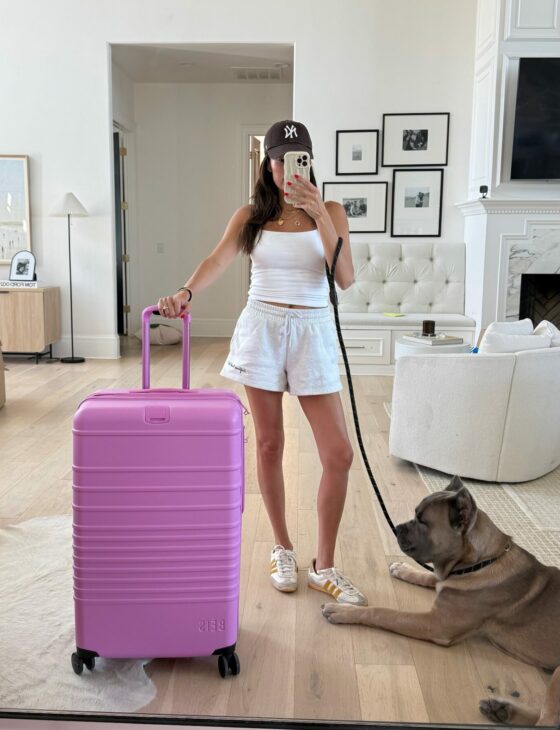 christine andrew travel outfit, baseball hat