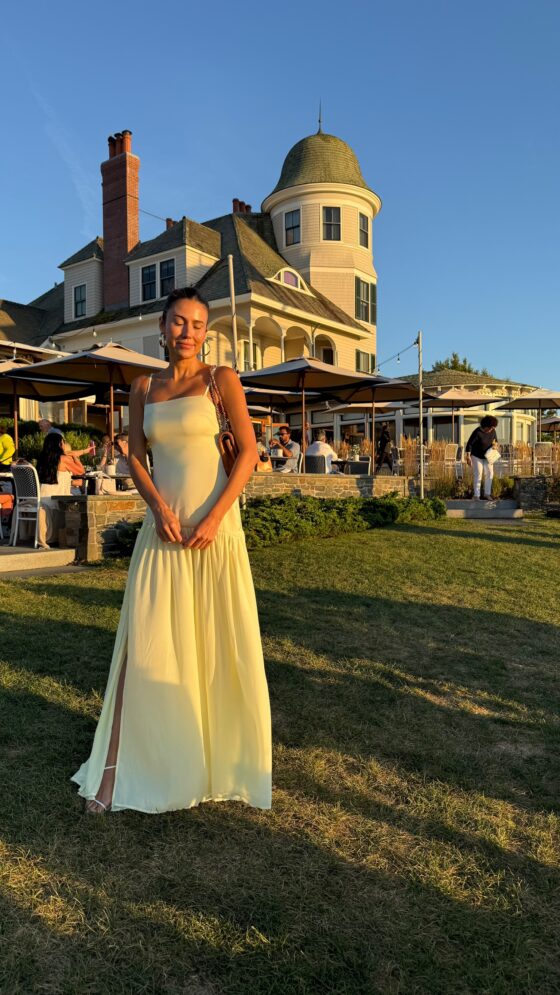 Christine Andrew in a butter yellow wedding guest dress 